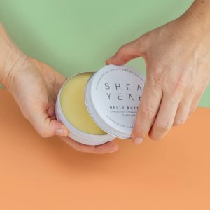 Zwei Hände öffnen die Belly Butter